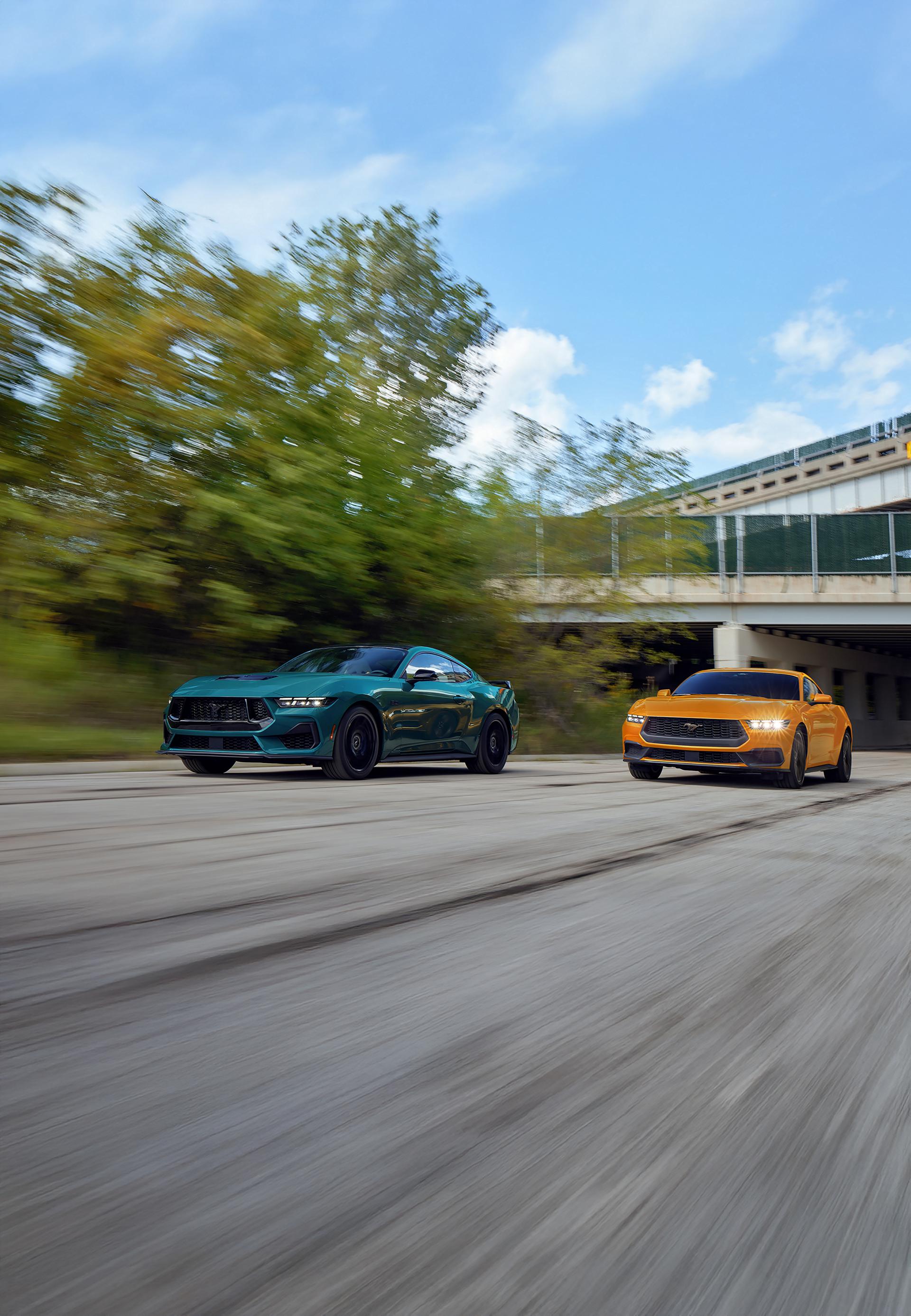 2026 Ford Mustang GT Fastback and EcoBoost Fastback on a highway
