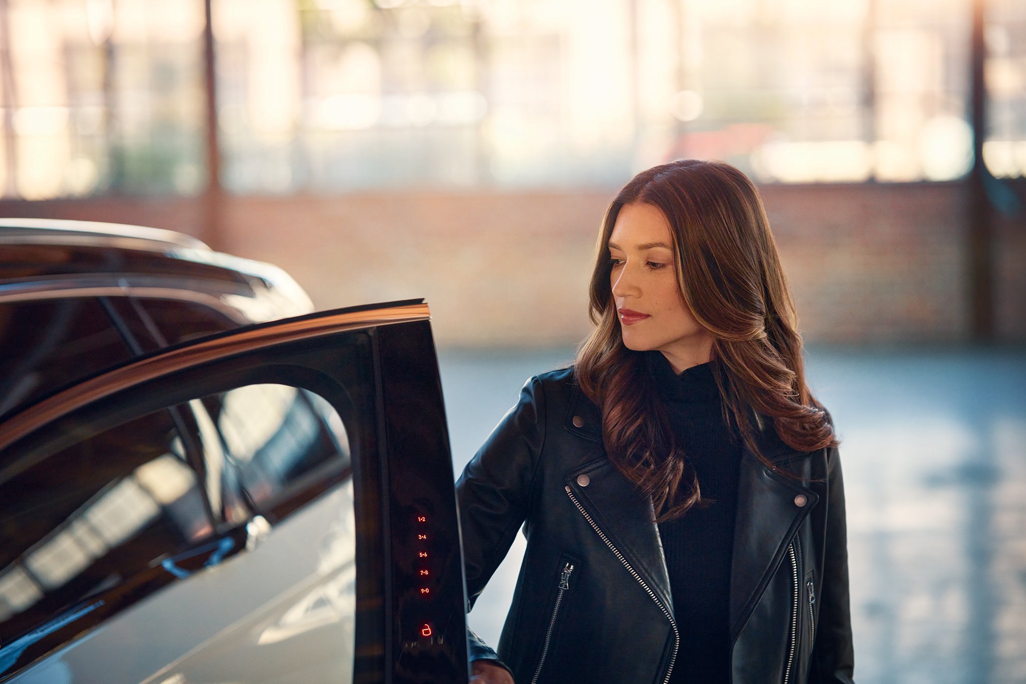 A woman gains entry to a Lincoln Nautilus by using Keyless entry system