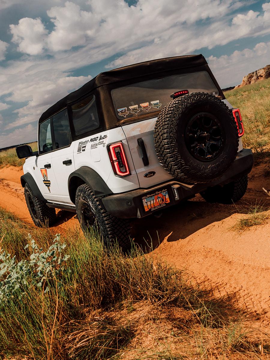 A 2026 Ford Bronco® SUV being driven on a dirt path in Moab, Utah