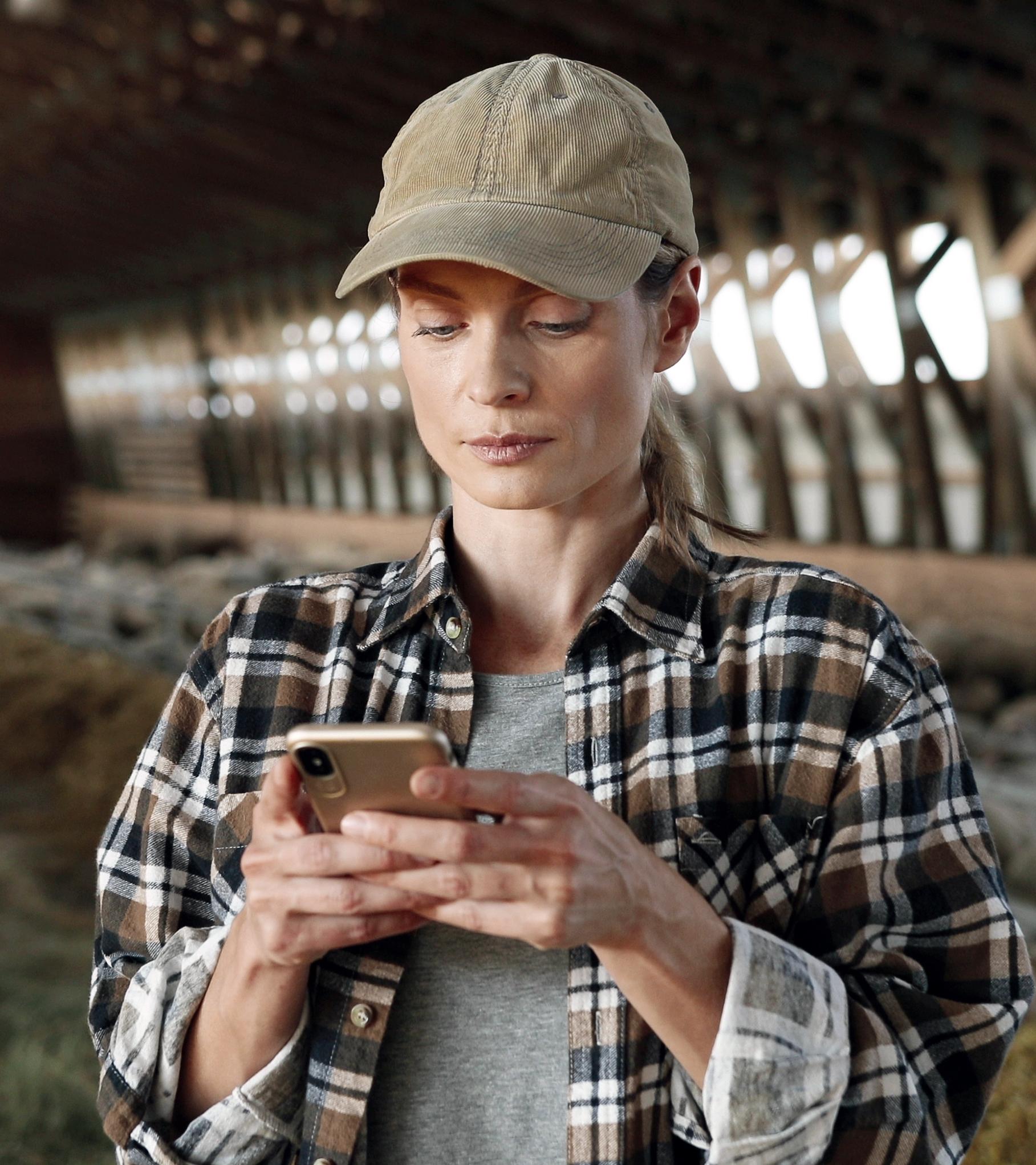Hand holding a mobile phone with the Ford app home screen in view