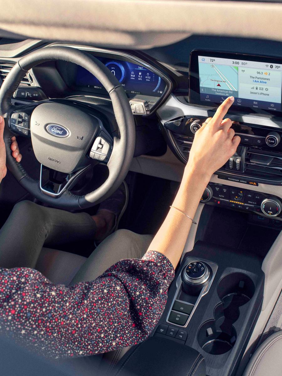 A woman driving a Ford vehicle