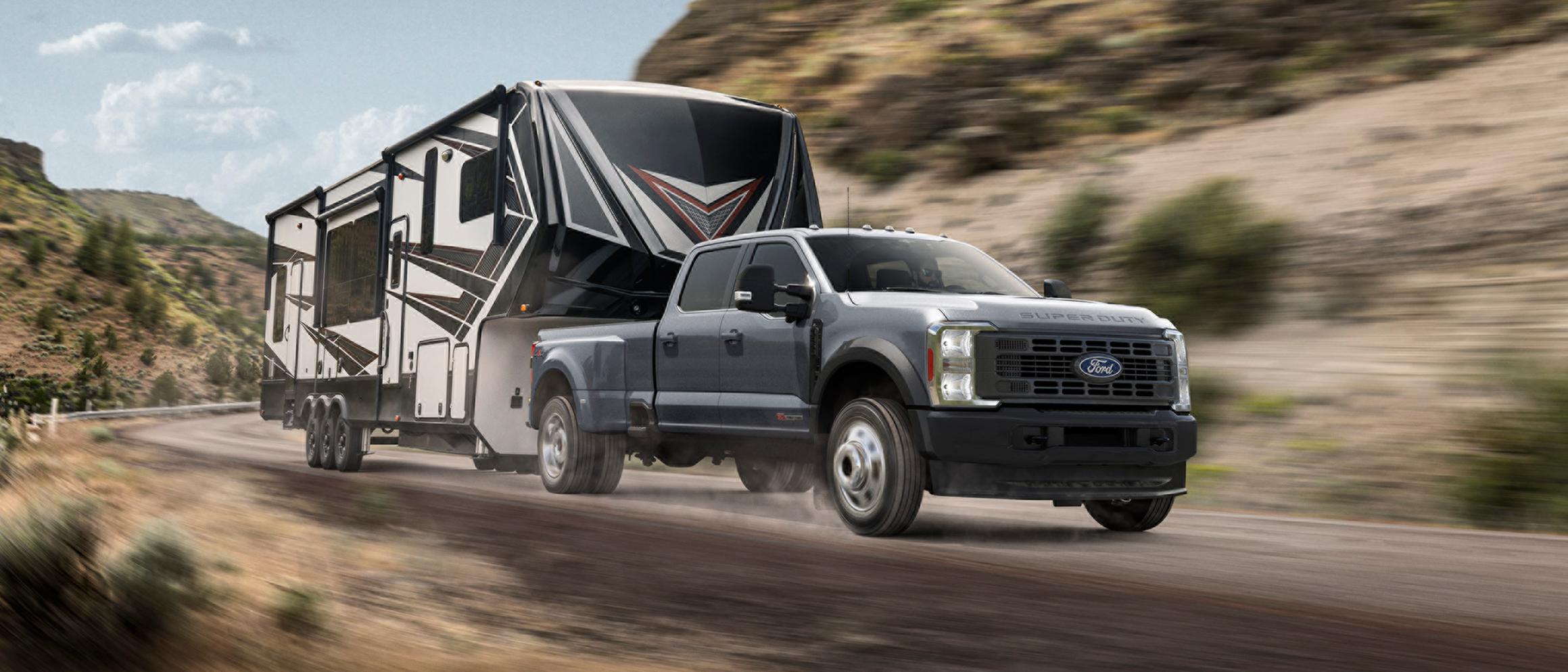 2027 Ford Super Duty® truck pulling a large trailer on a mountain road