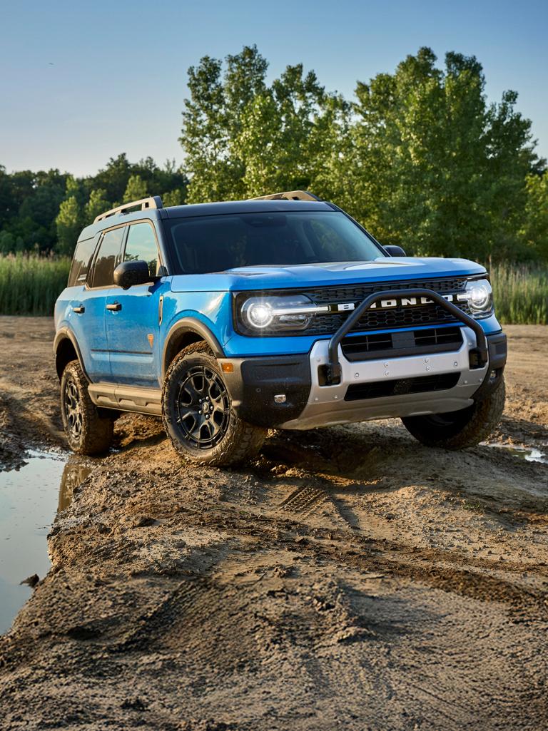 A blue 2026 Ford Bronco Sport® Badlands® advances on a muddy trail