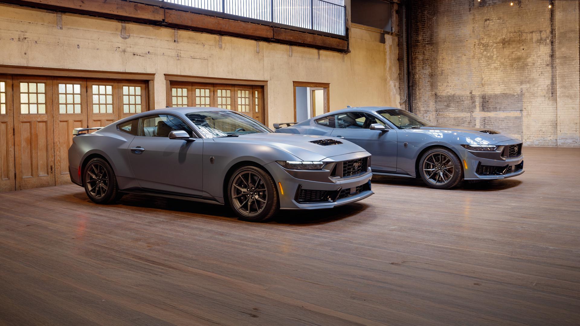 Two 2026 Ford Mustang® Fastbacks parked in a garage, one with the available Matte Clear Film
