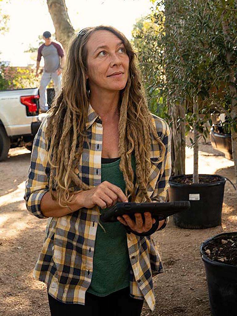 Woman holding tablet at garden nursery