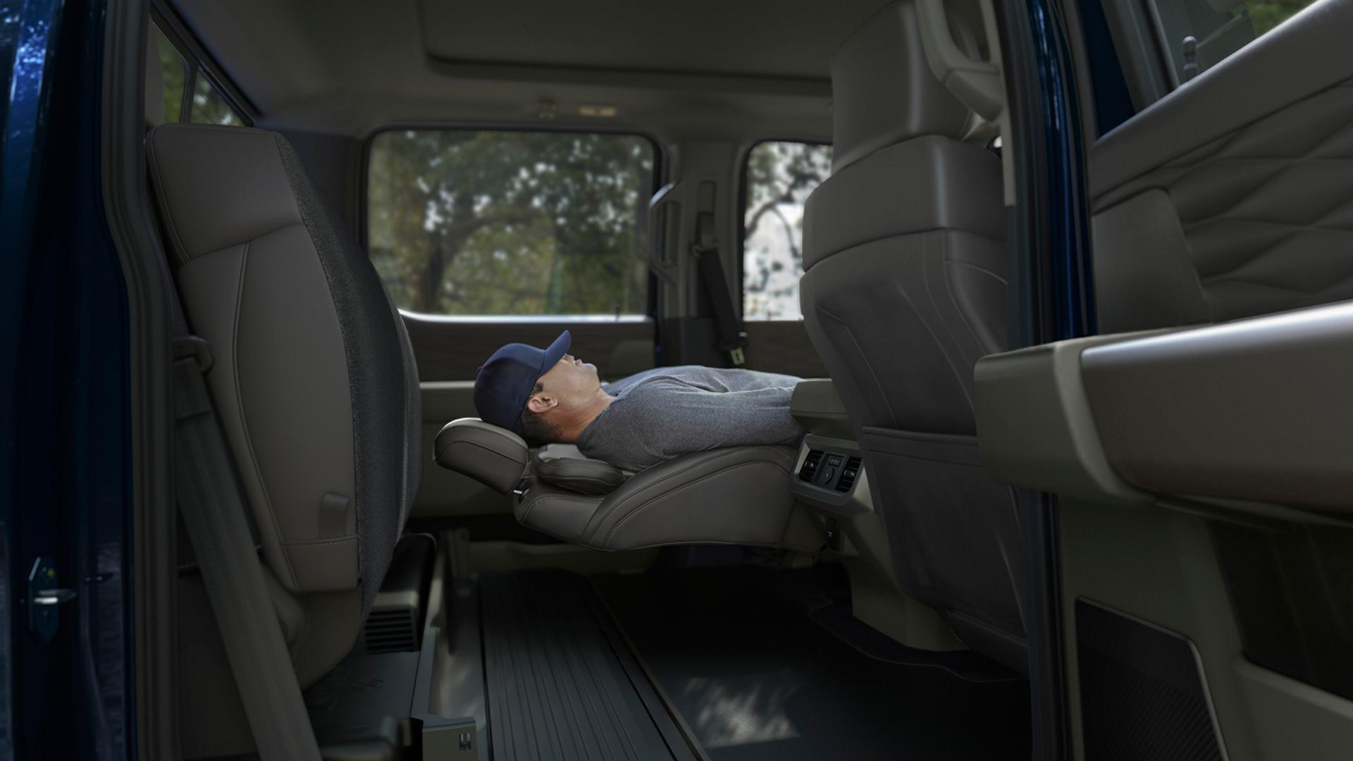 Person napping in their 2027 Ford Super Duty® F-350® Platinum® model using the Max Recline Front Seats feature