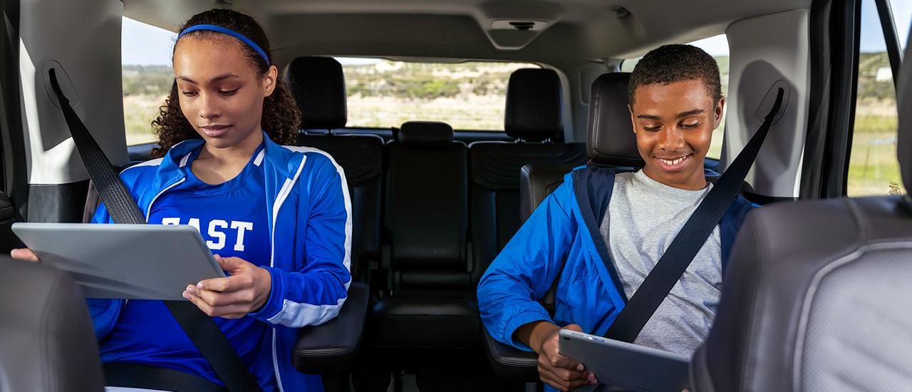 Two passengers in the second row using tablets in a 2027 Ford Expedition® SUV