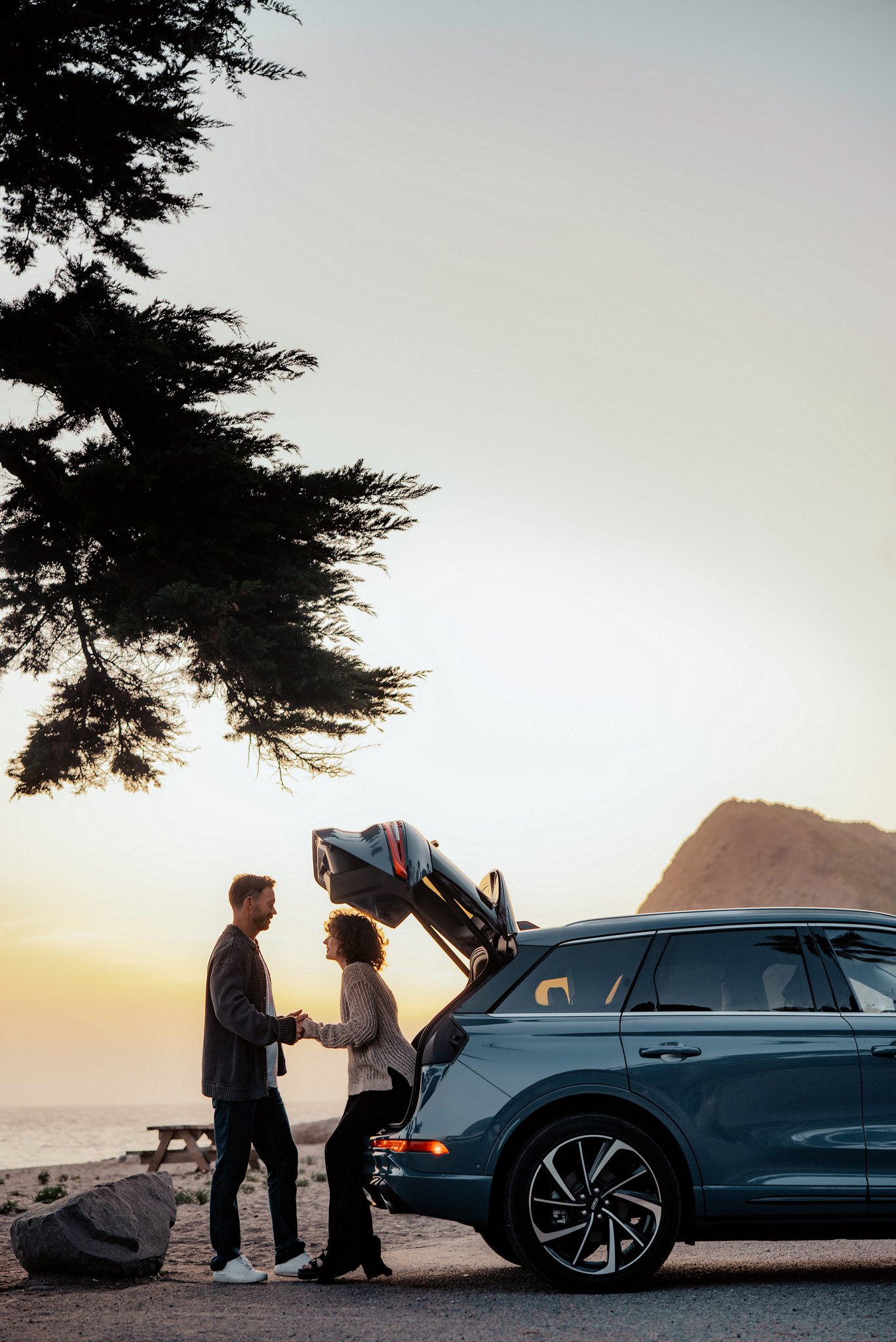 A woman sits in the rear of a 2025 Lincoln Corsair® SUV with the rear lift gate open