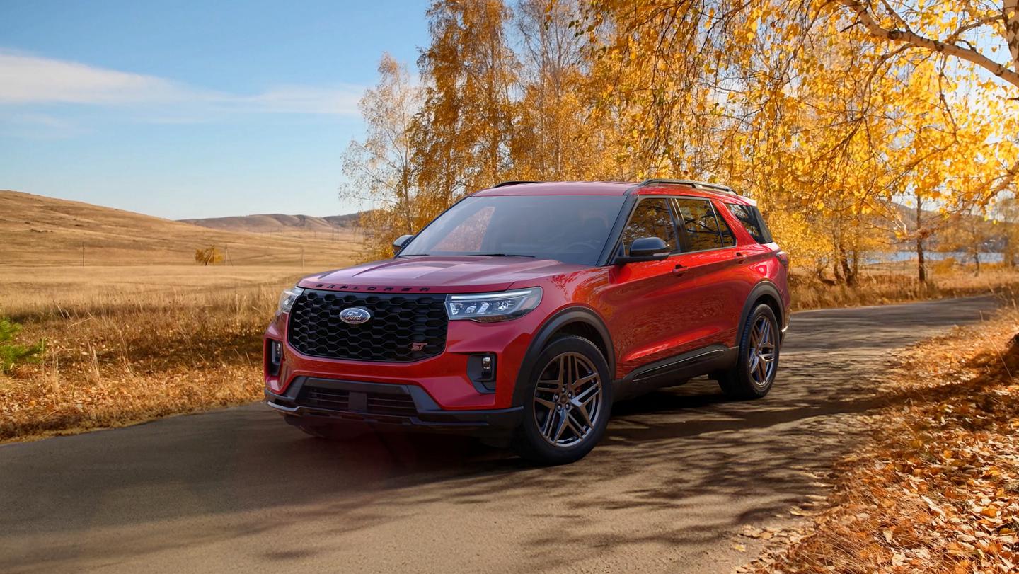 A 2026 Ford Explorer® SUV on a road through a field in the fall