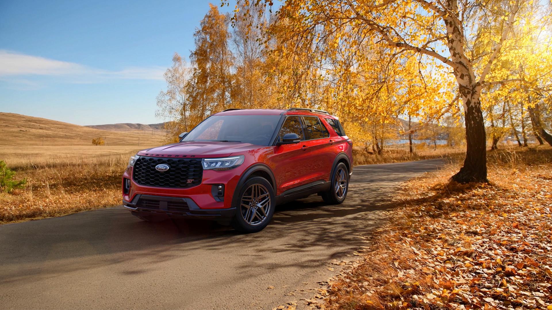 A 2026 Ford Explorer® SUV on a road through a field in the fall