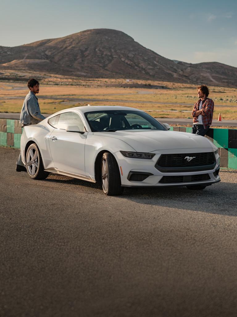 2026 Ford Mustang® EcoBoost® fastback parked on a racecourse near people