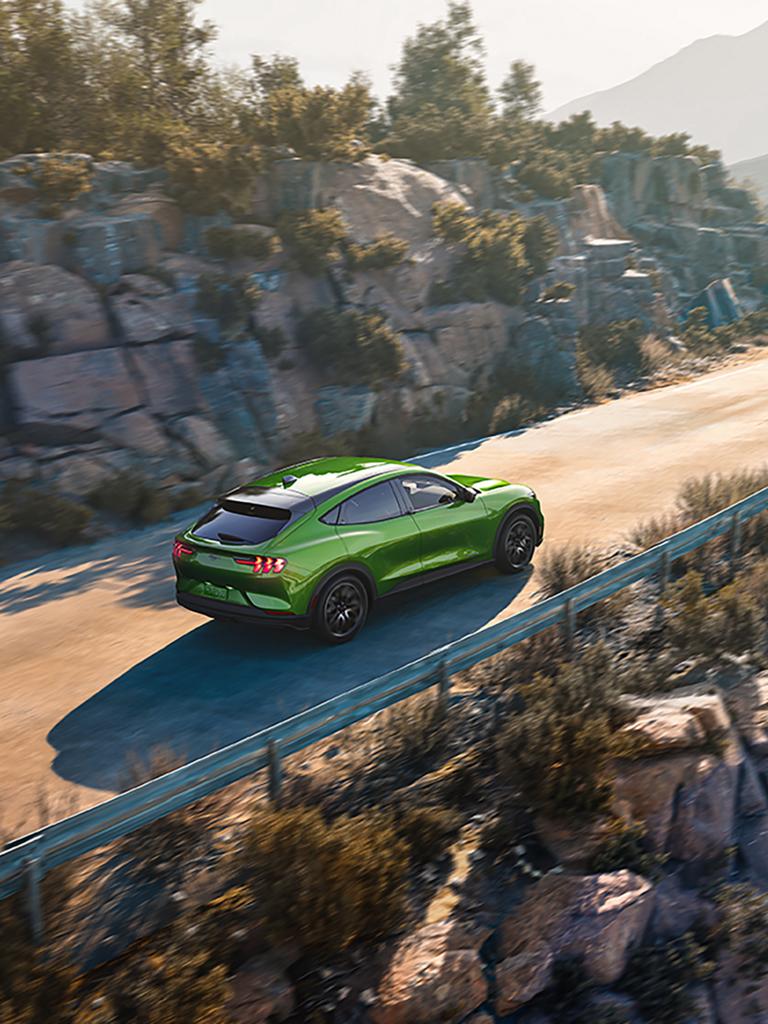 Aerial view of a 2026 Ford Mustang Mach-E® SUV being driven on a mountain road