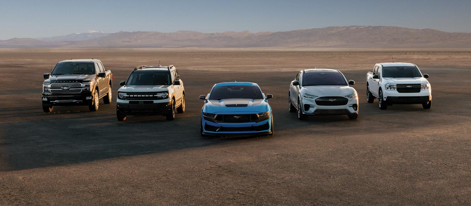 Five Ford vehicles parked in the desert