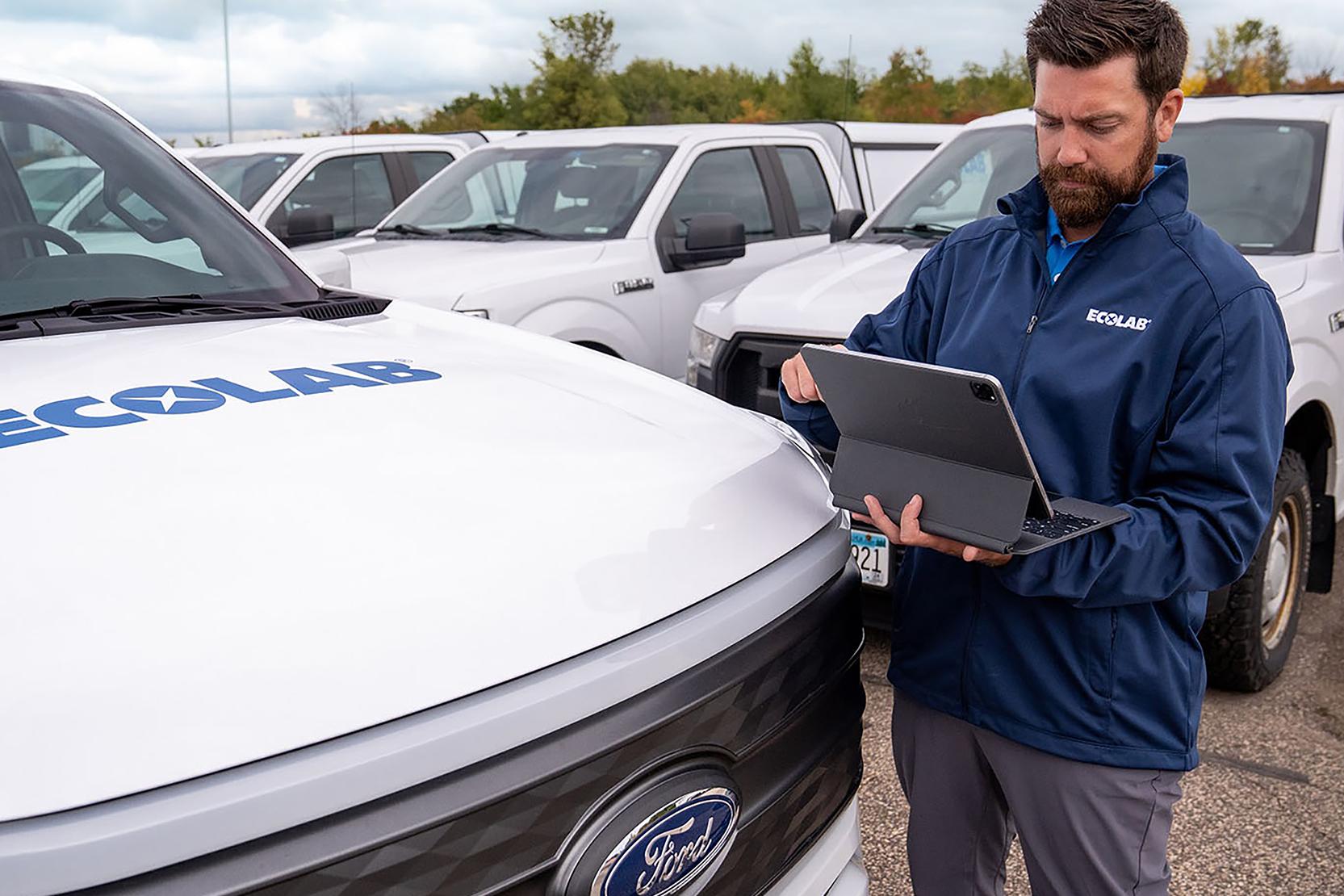 Man standing by Ecolab vehicle