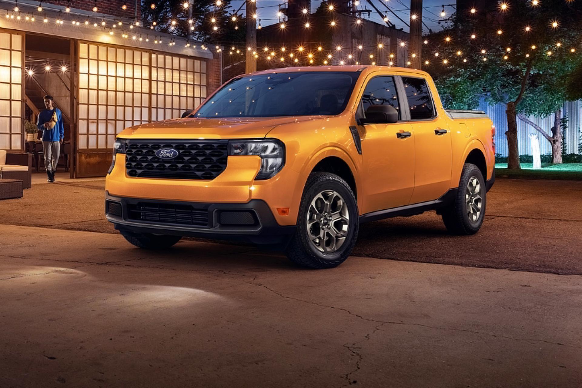 Orange 2026 Ford Maverick® truck parked under festive lights