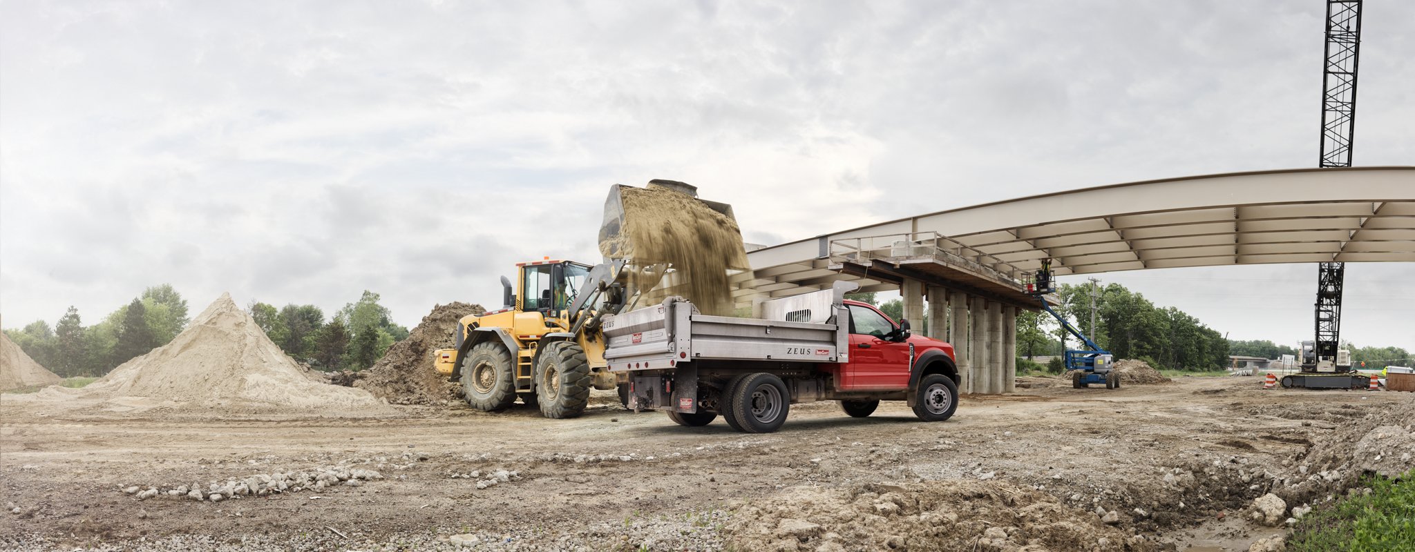 2025 Ford Super Duty® F-550® XL with a dump bed being filled with dirt