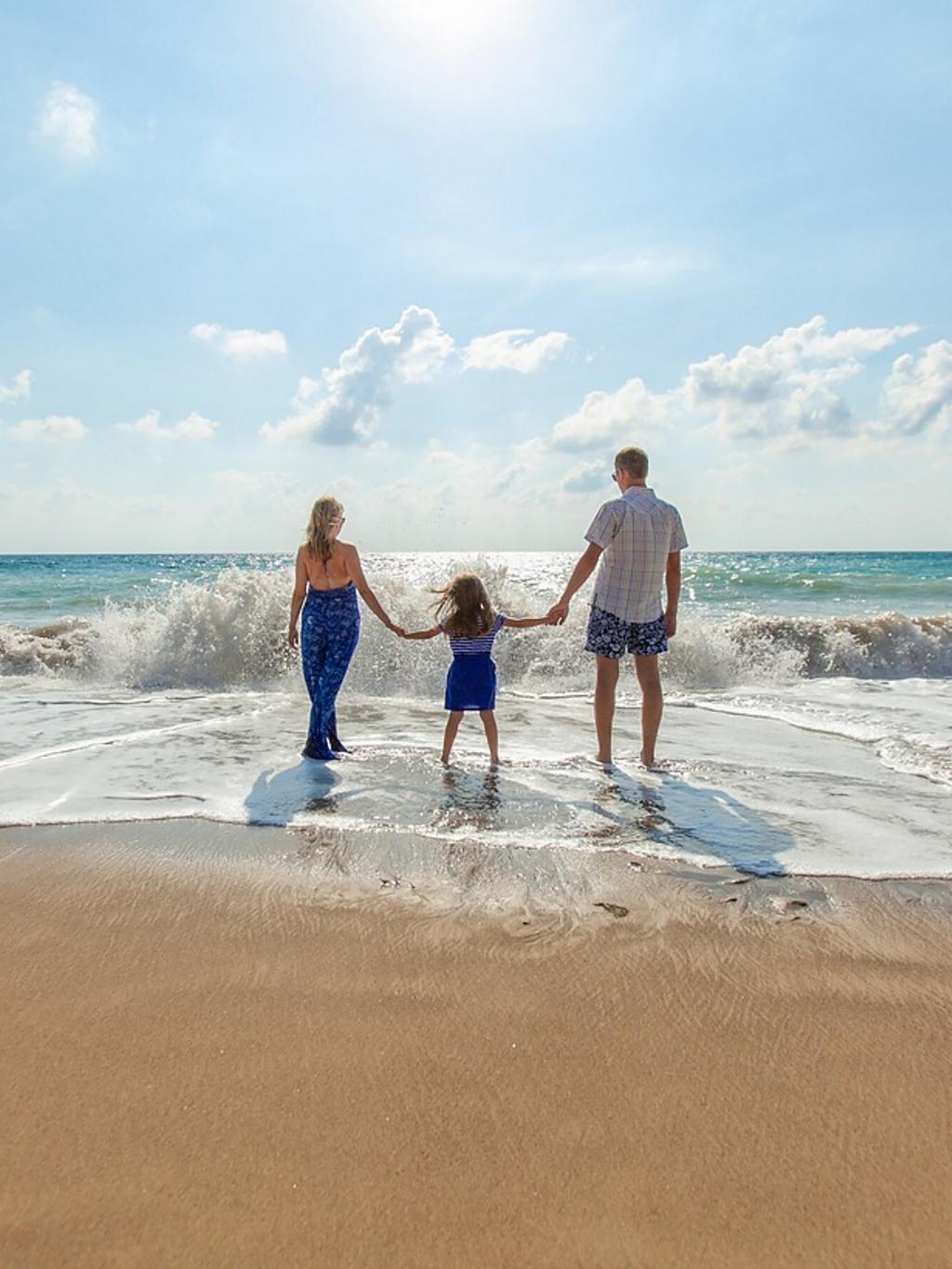 A family standing on the beach.