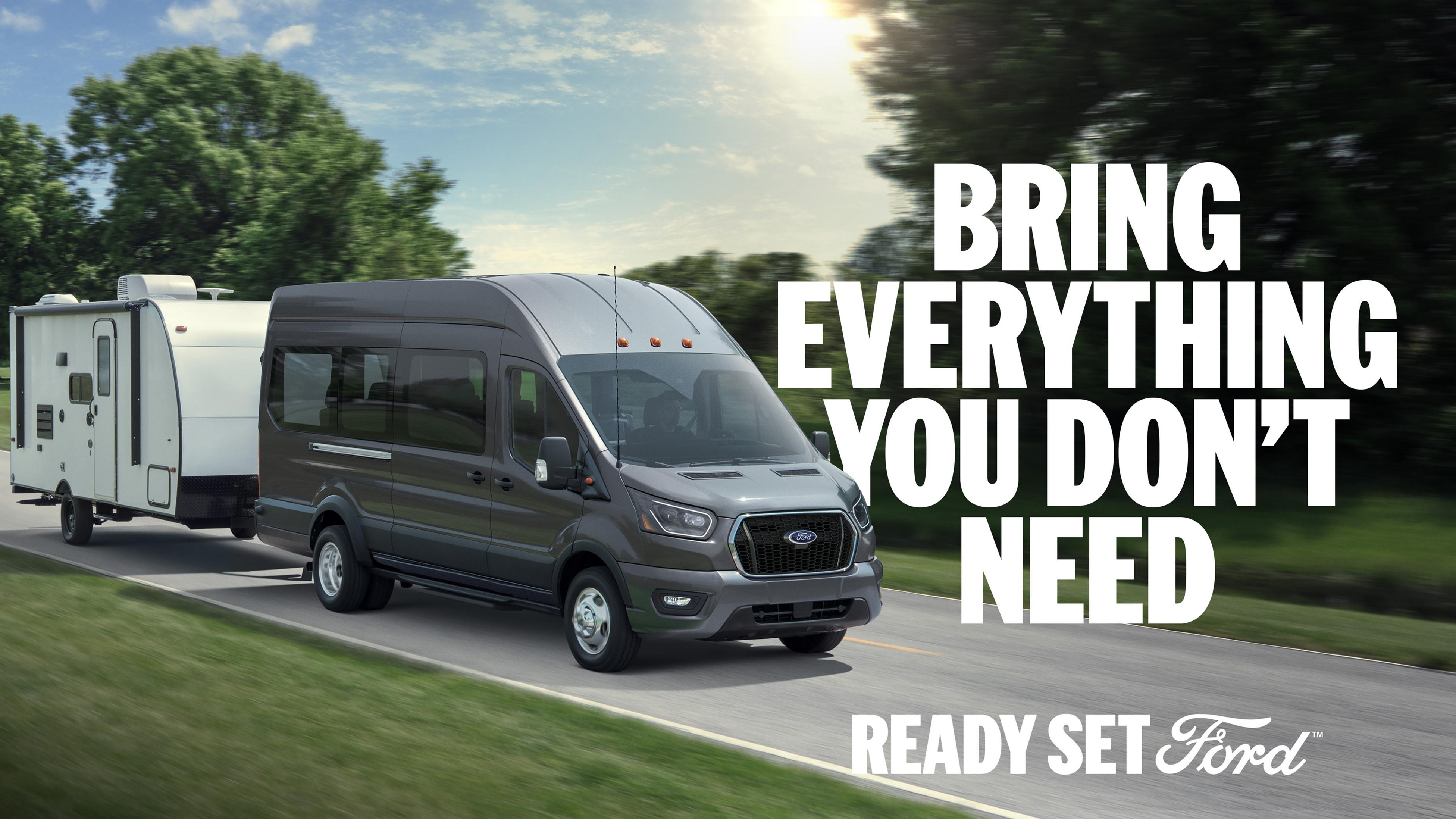 A 2026 Ford Transit® van towing a large item