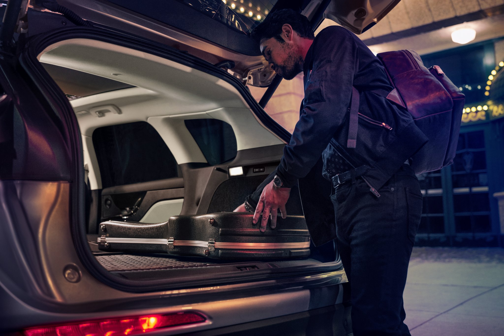 A person loads music equipment into the rear cargo area of a 2026 Lincoln Corsair® SUV