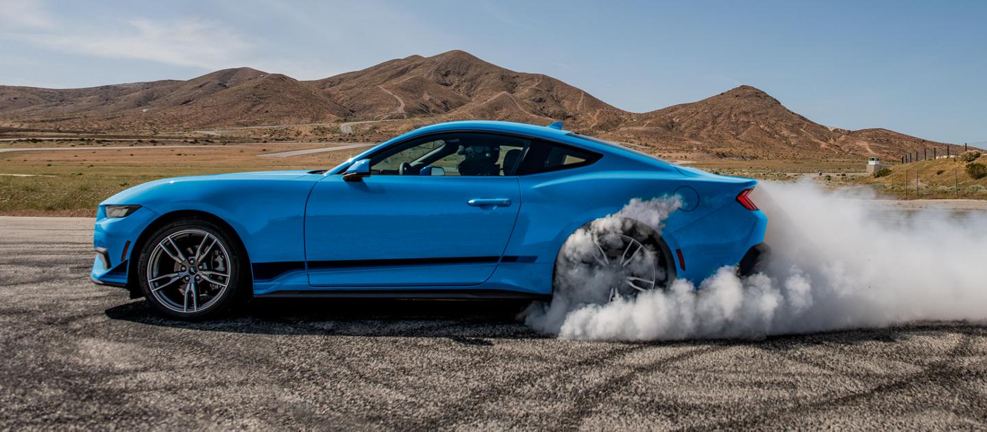 2025 Ford Mustang® EcoBoost® coupe in with a driver doing burnouts on a closed course