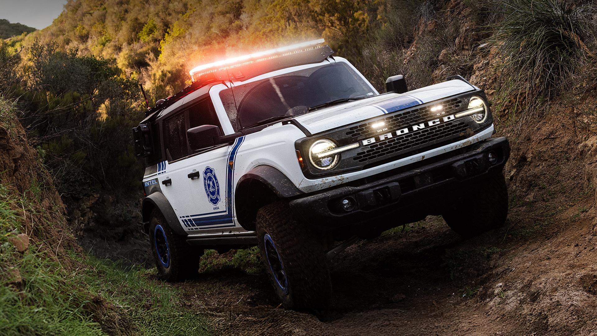 A Ford Bronco Badlands equipped with search and rescue gear driving on an incline.