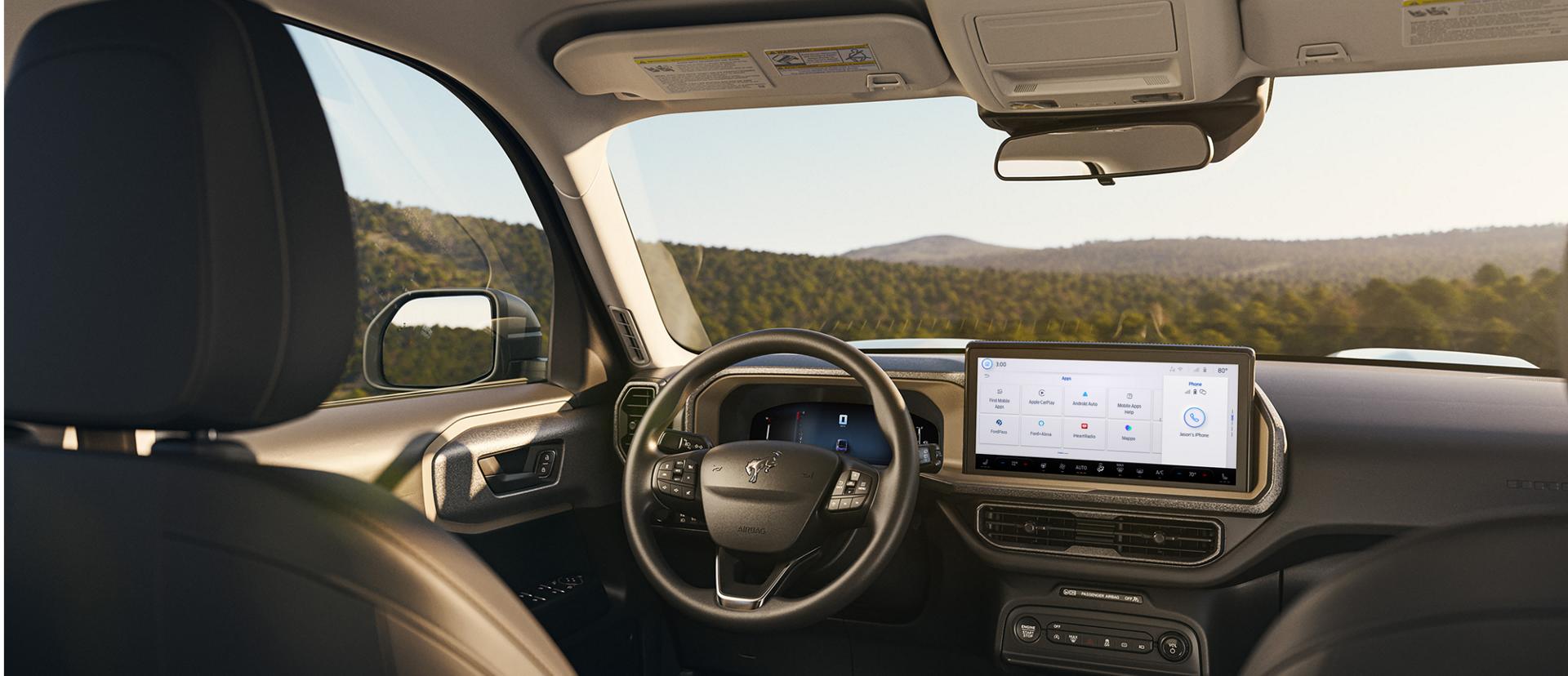 Interior of vehicle shown, highlighting the screen in the center console