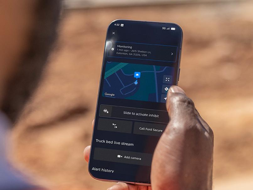 Person holding a phone displaying the Start Inhibit feature
