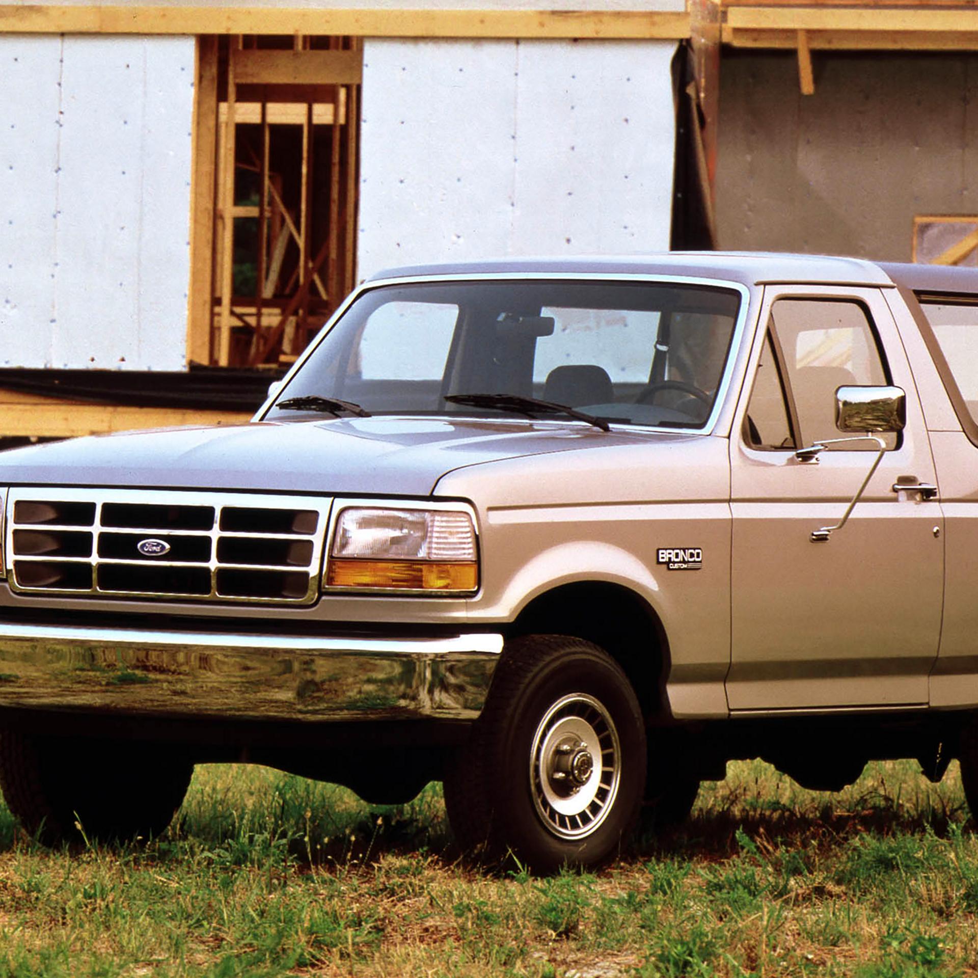 A vintage tan 1992 Ford Bronco® model parked near a construction site