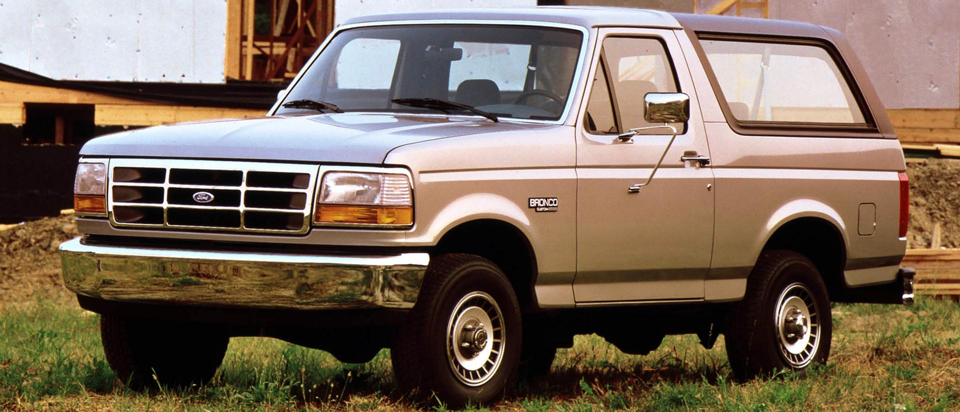 A vintage tan 1992 Ford Bronco® model parked near a construction site