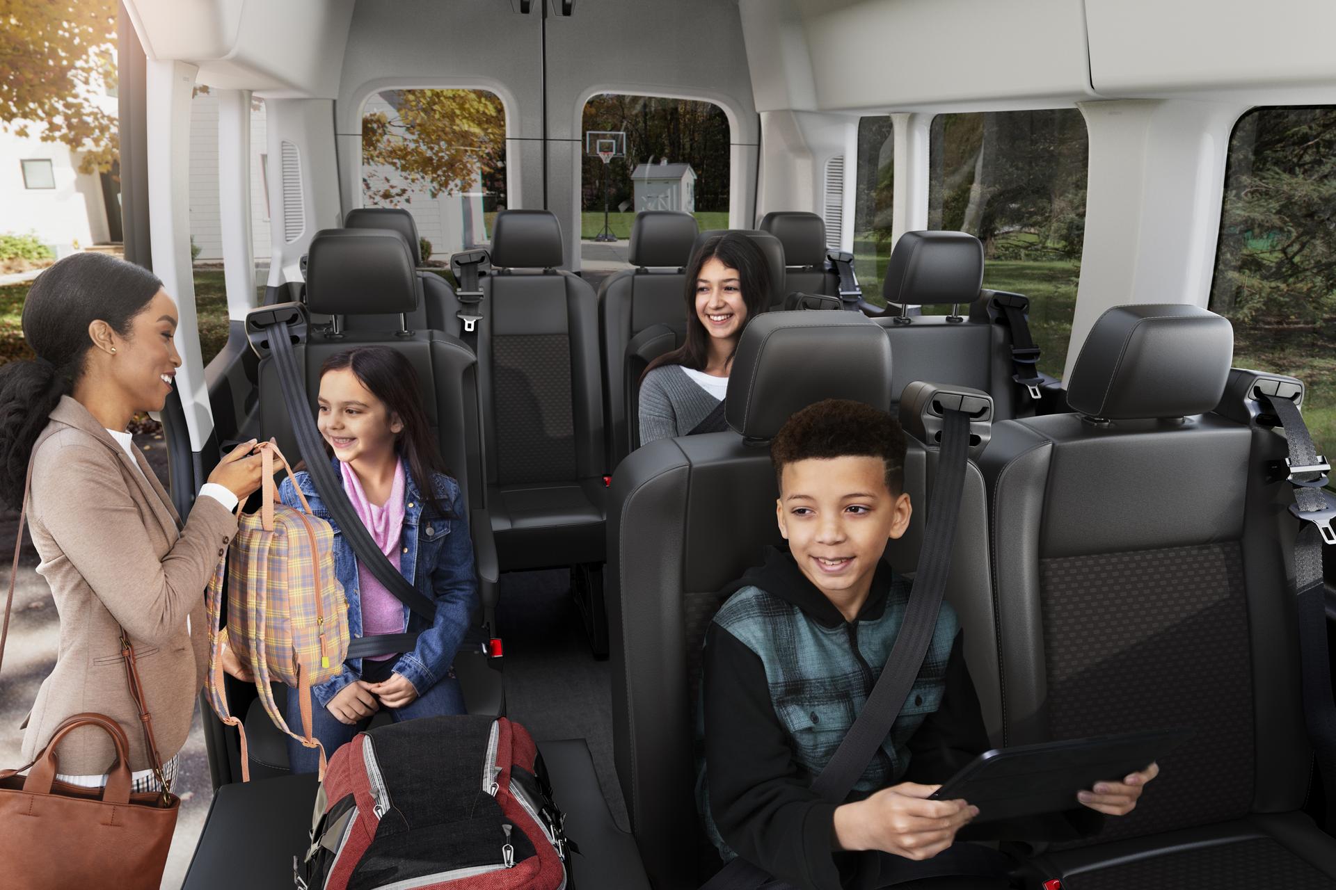 Family buckling seat belts inside a 2026 Ford Transit® van
