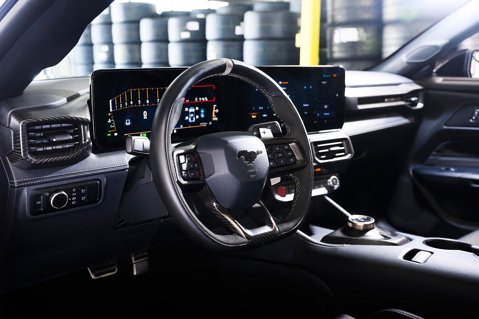 Close up the steering and wheel and dual screens on the 2026 Ford Mustang GTD