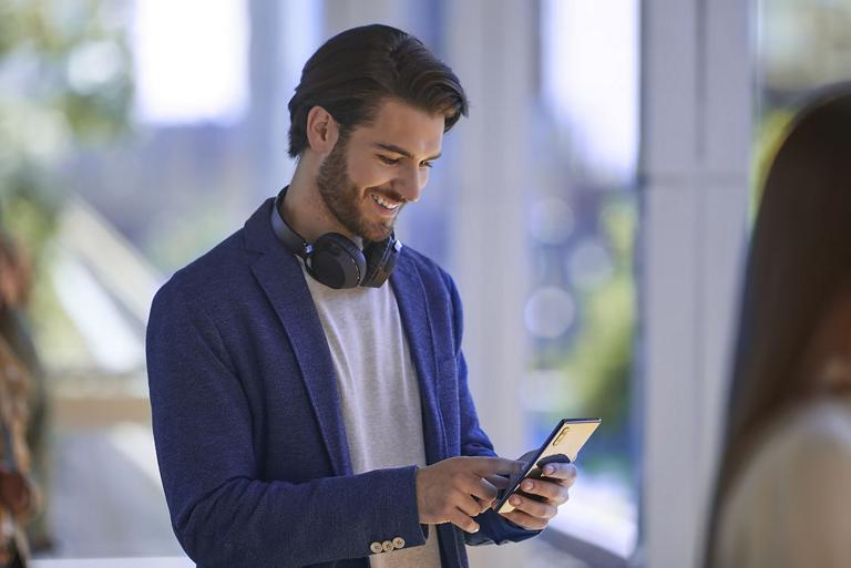 A Ford owner checks their FordPass® rewards points on their phone