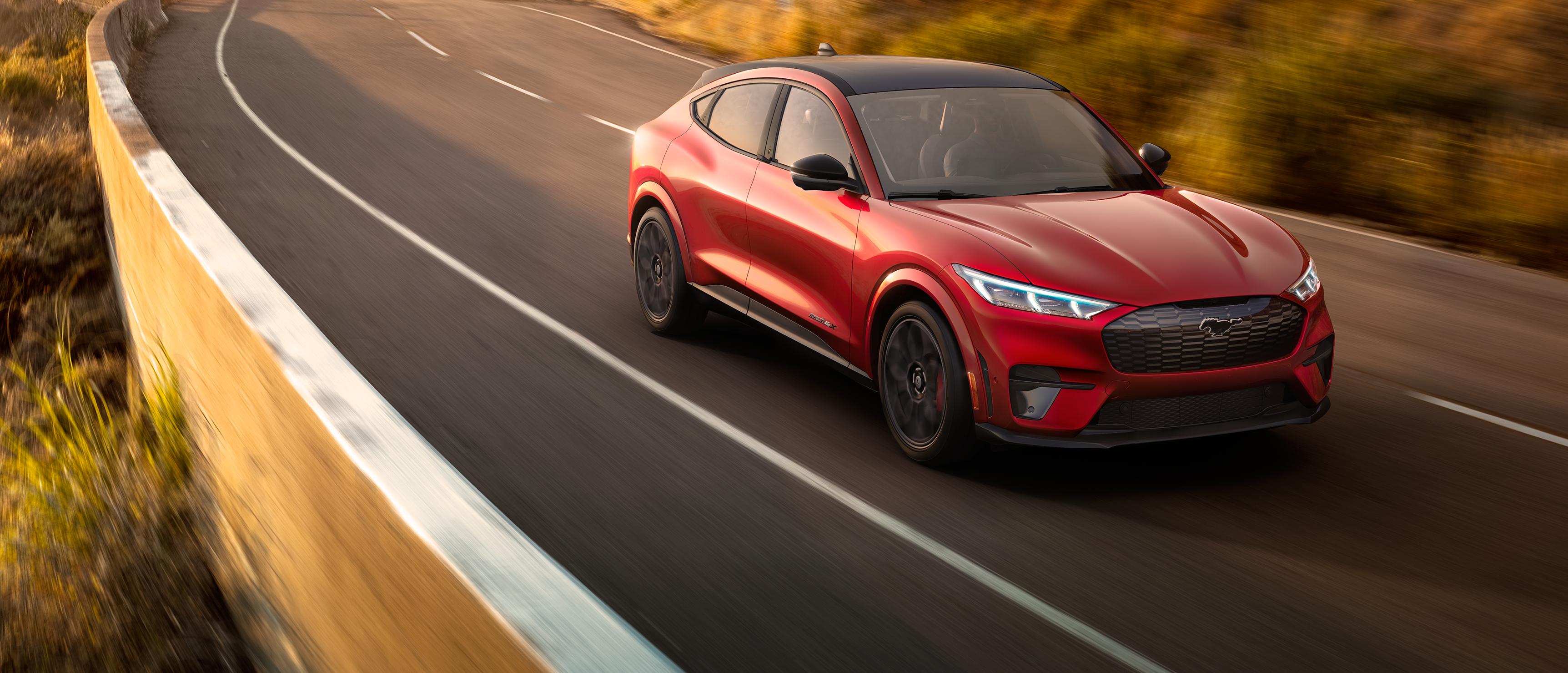 The Ford Mustang Mach-E® SUV cruises down a scenic route