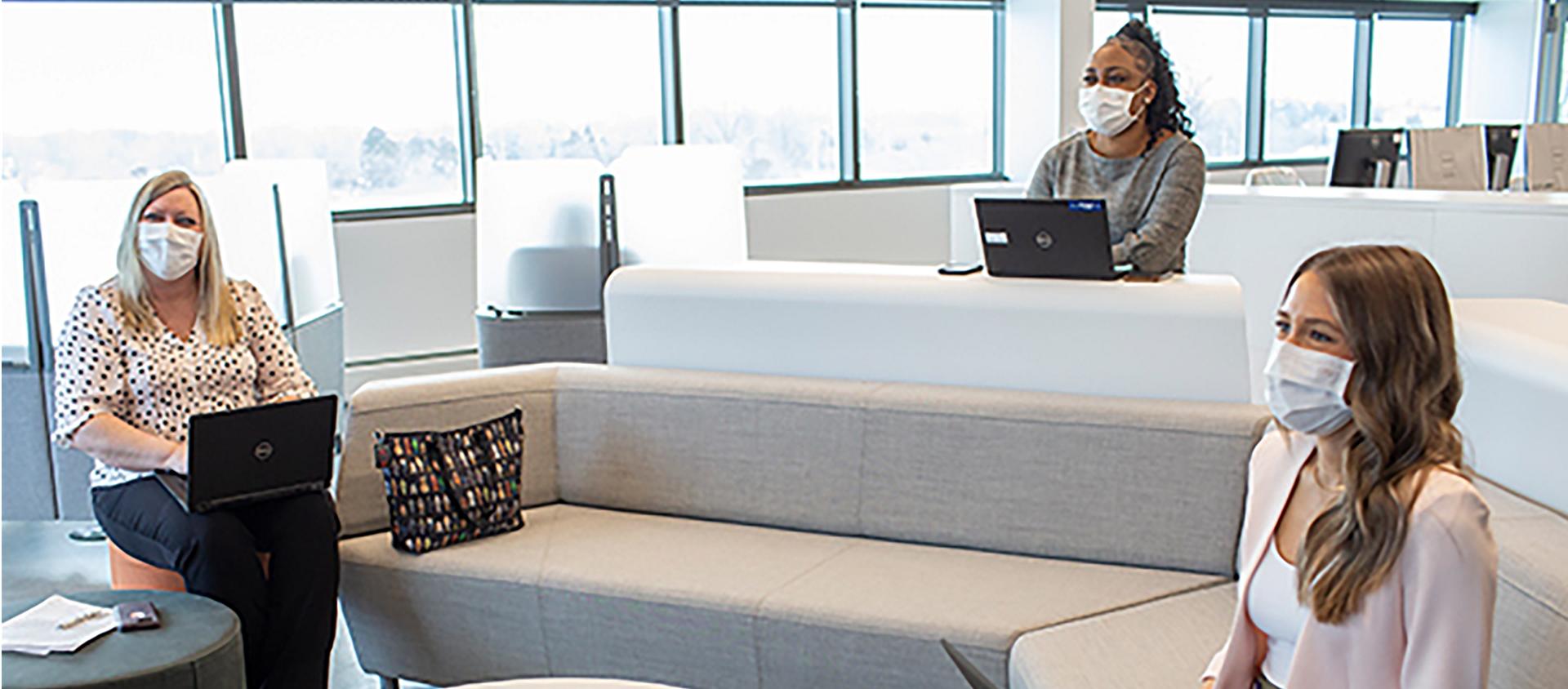 Three women sitting in office
