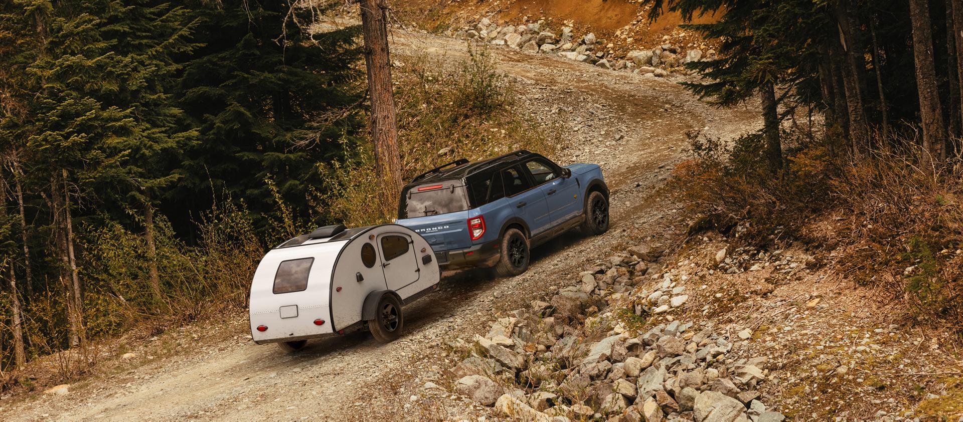 2026 Ford Bronco Sport® being driven with a trailer being towed behind it