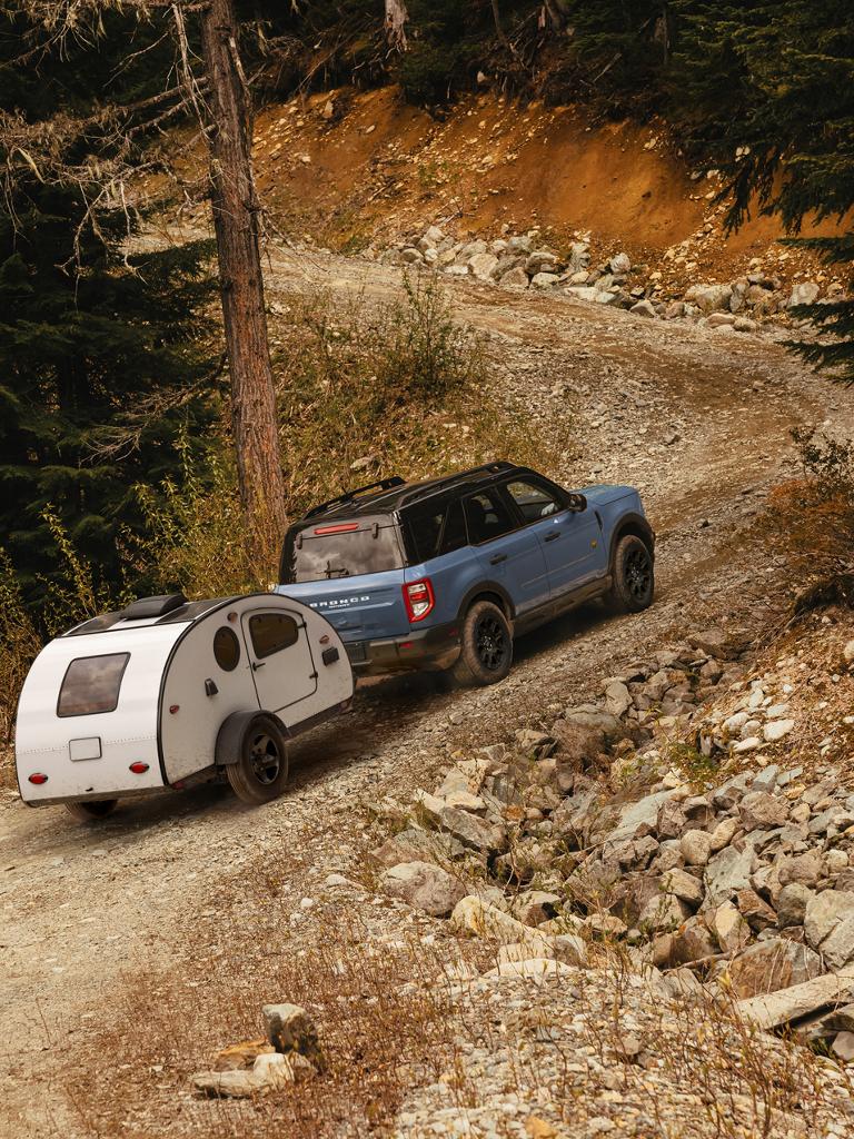 2026 Ford Bronco Sport® being driven with a trailer being towed behind it