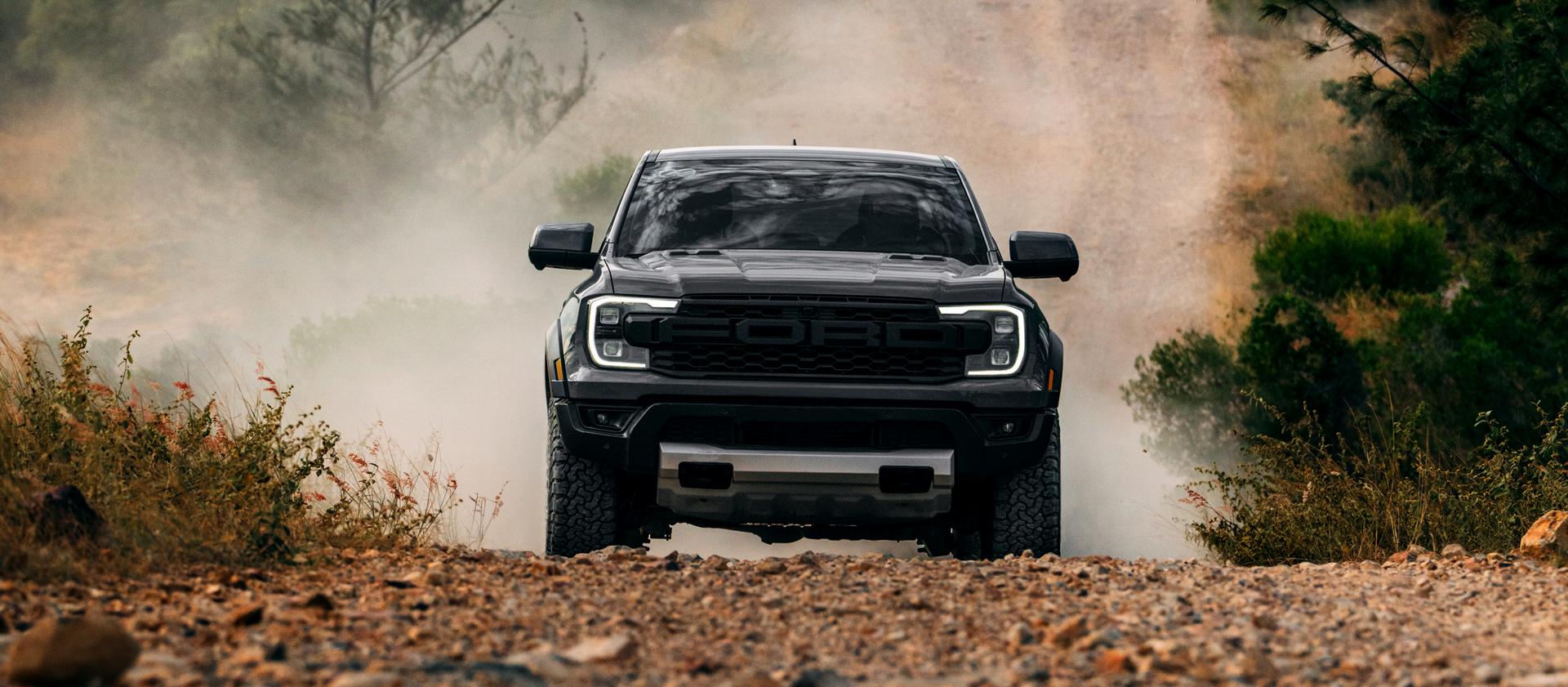 2026 Ford Ranger Raptor® model kicking up dirt while off-road driving