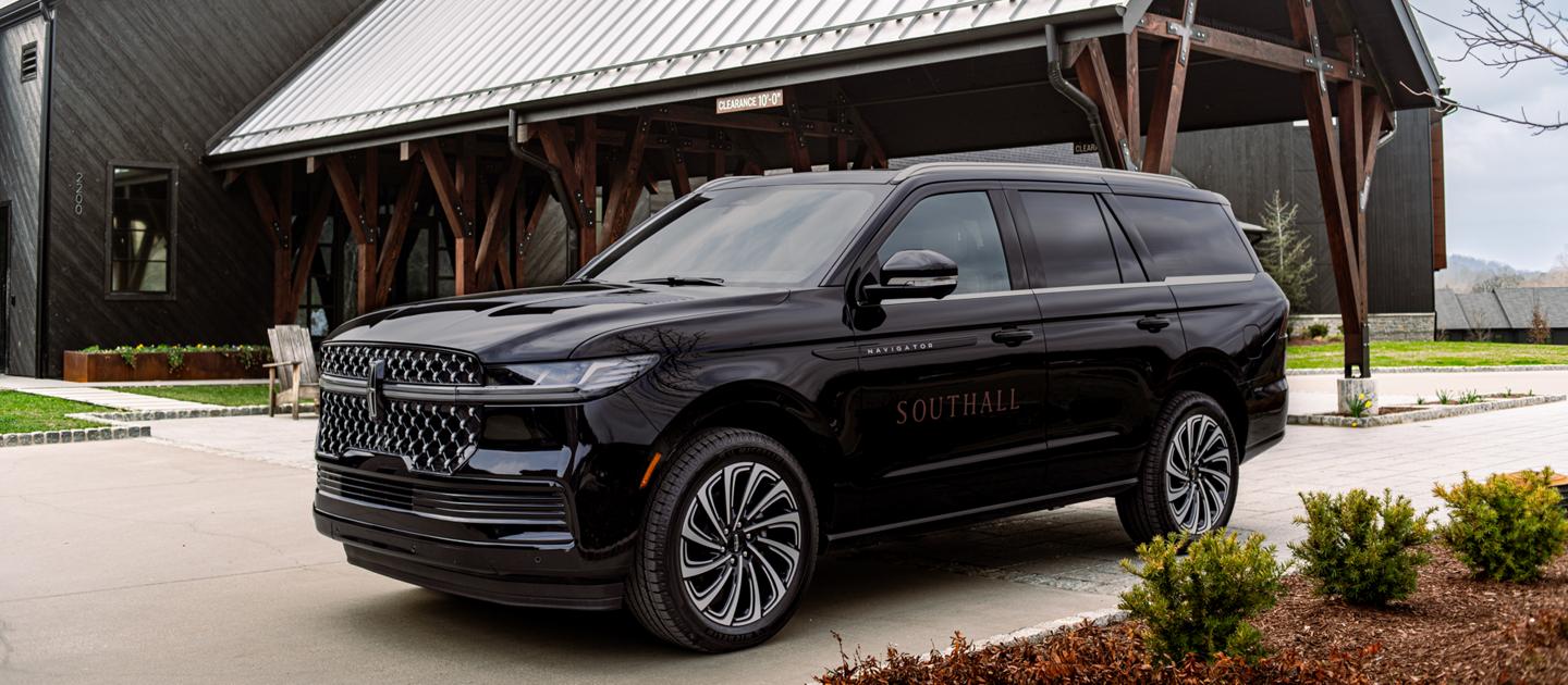 The Lincoln Navigator shown parked outside a building.