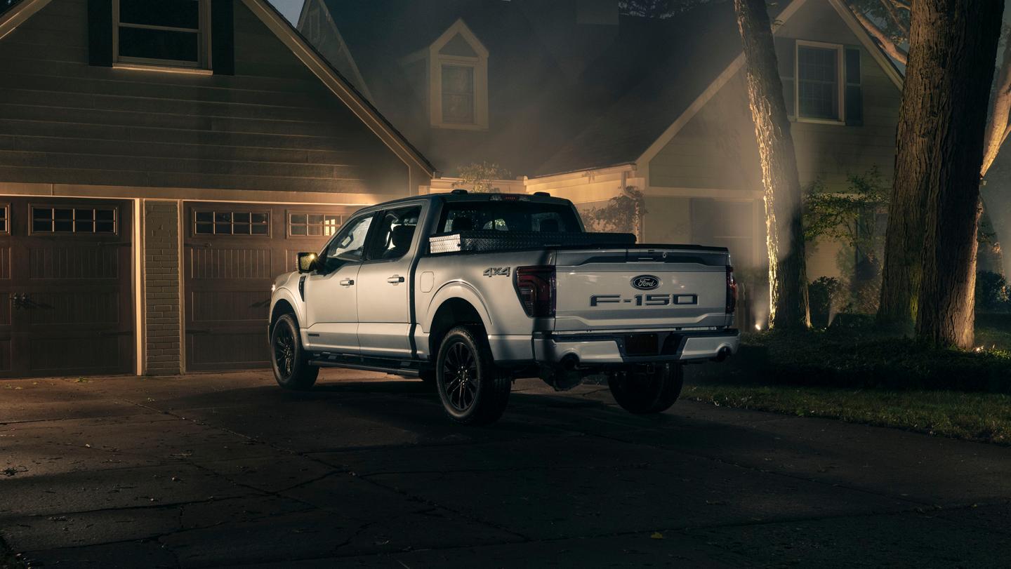 Ford F-150 parked in a residential driveway at night.