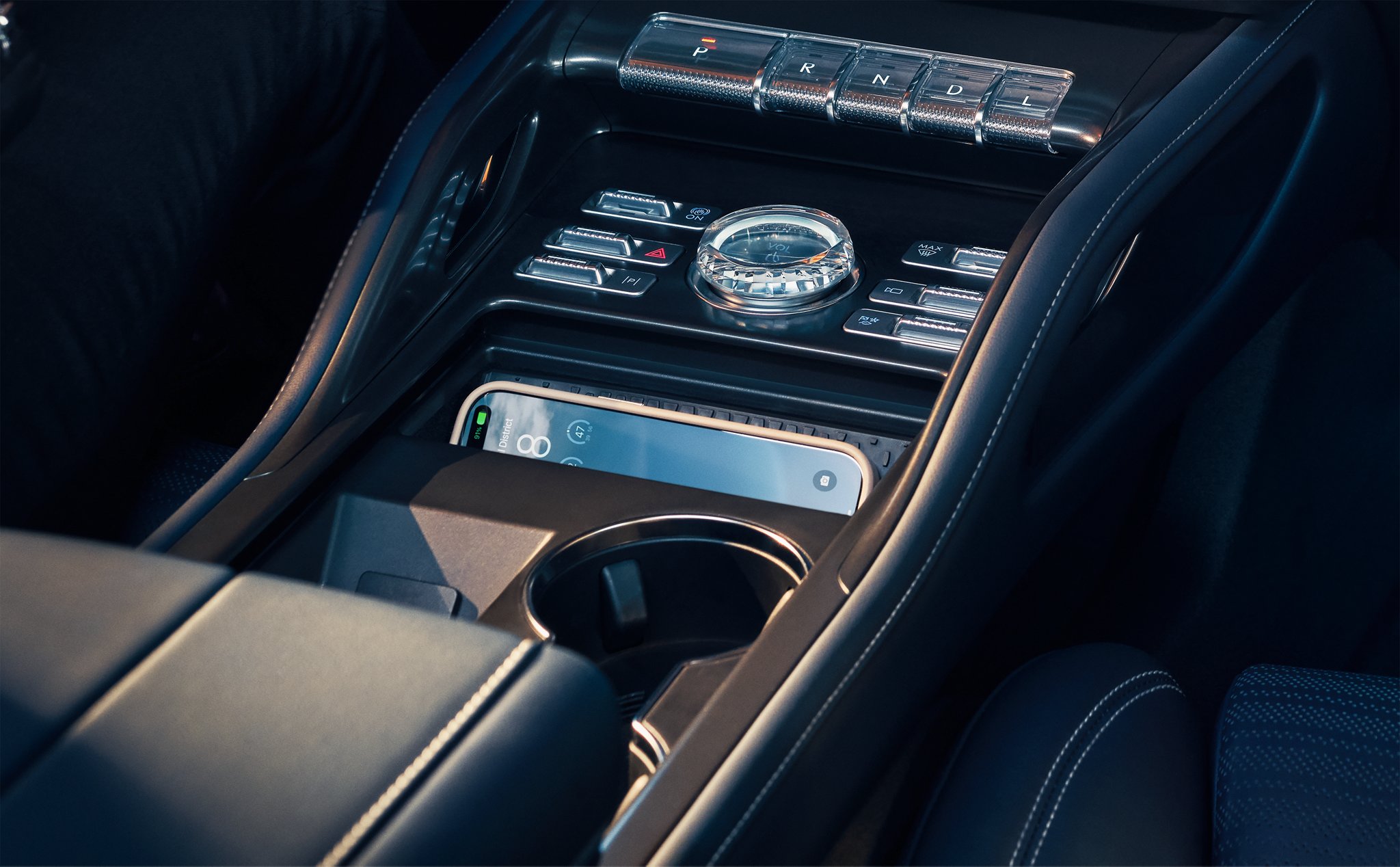 A smartphone is charging on the wireless charging pad