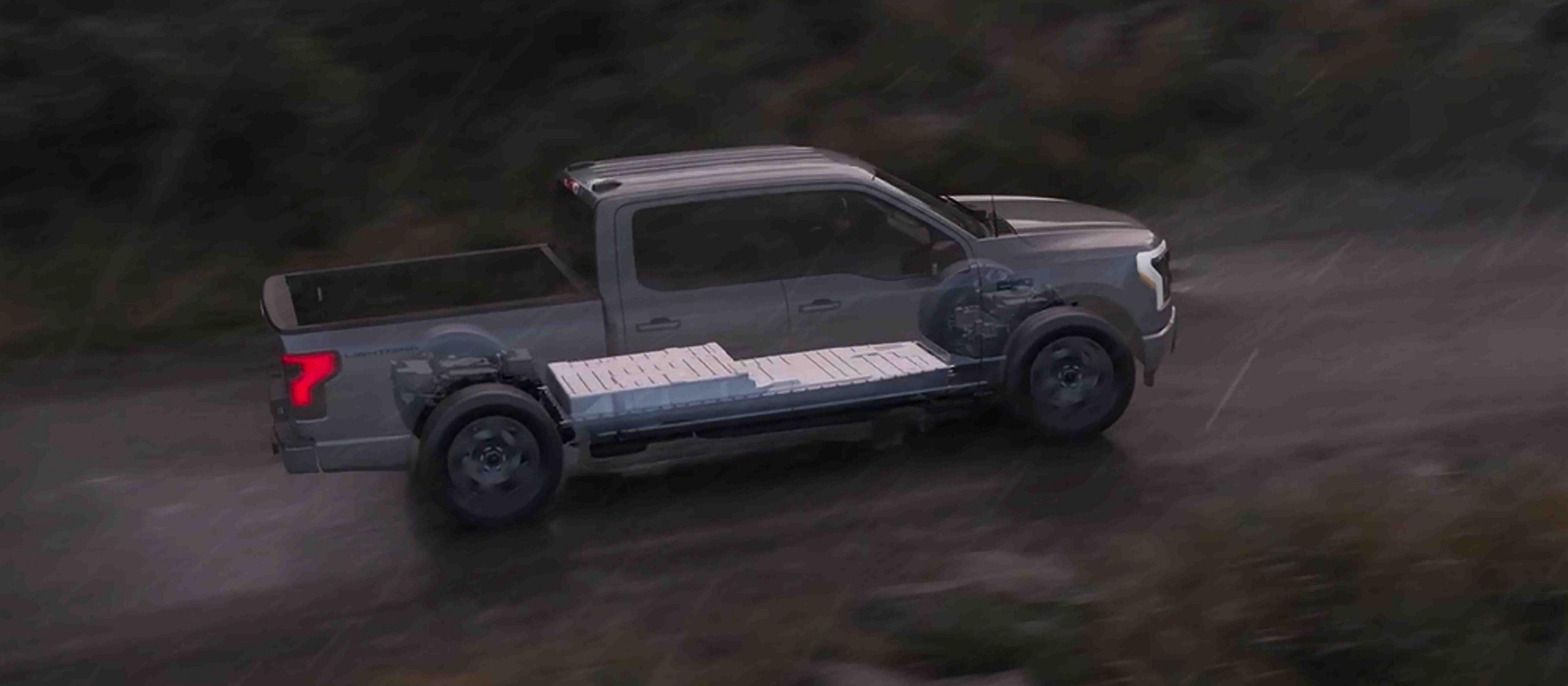 An illustration of a 2025 Ford F-150® Lightning® pickup on a gravel road, showing battery packs under the vehicle