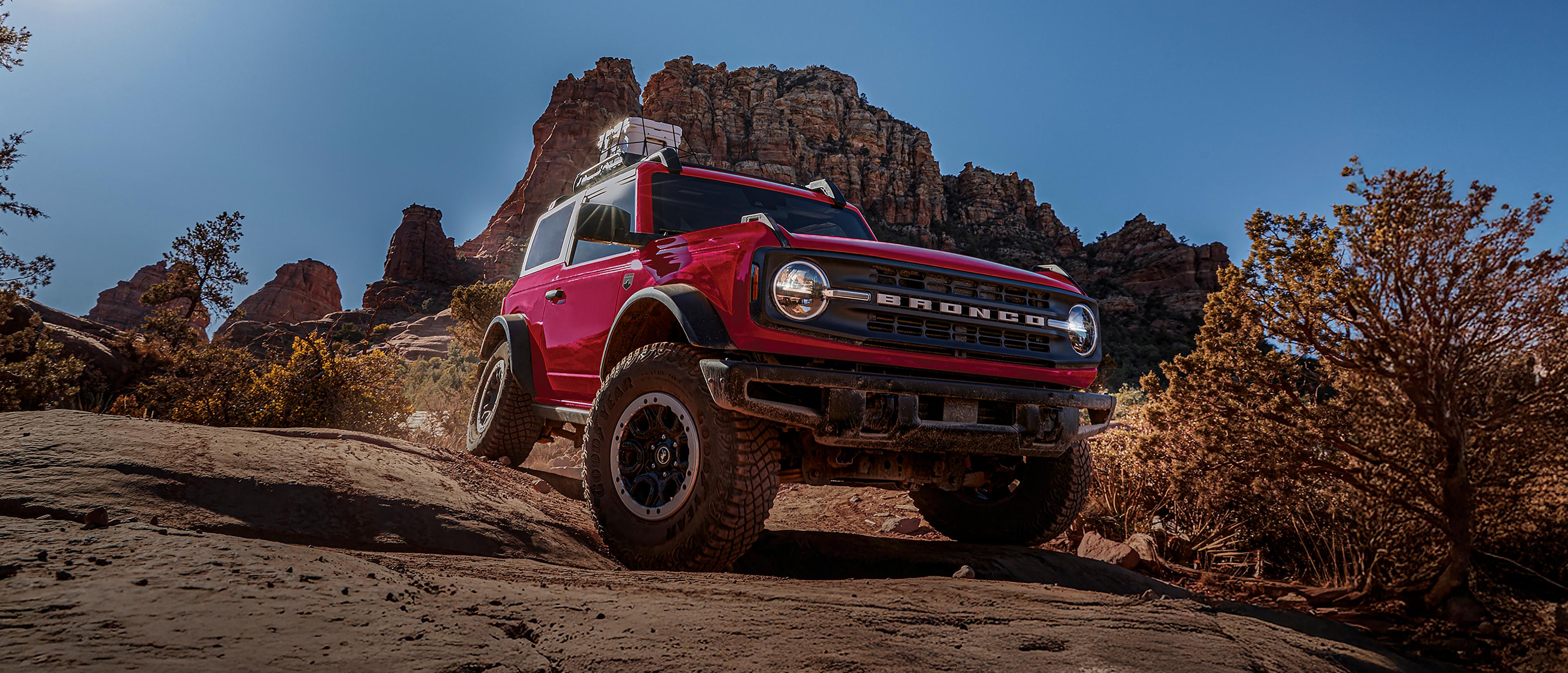 A 2026 Ford Bronco® SUV with the available Sasquatch® Package descending a muddy hill