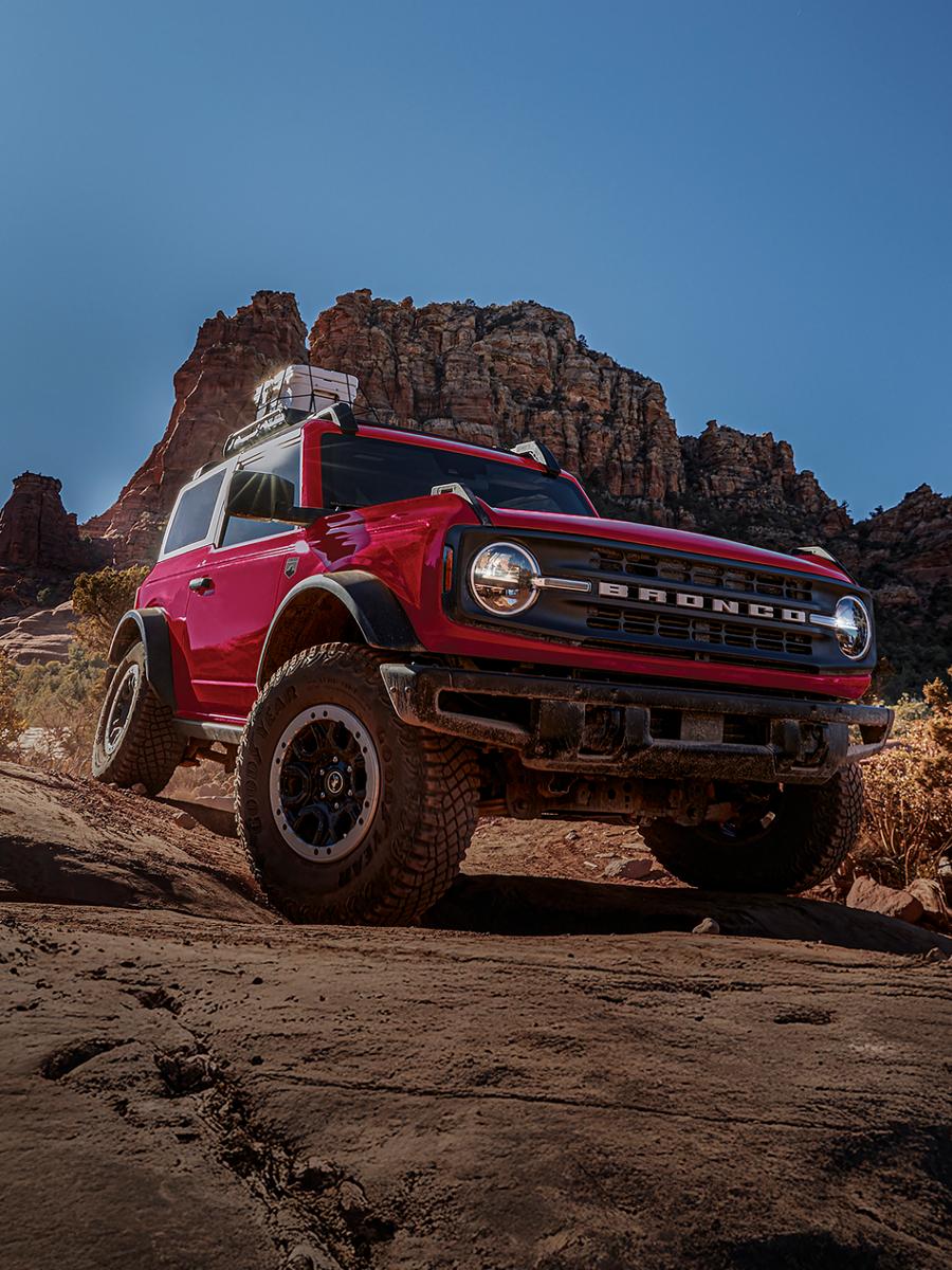 A 2026 Ford Bronco® SUV with the available Sasquatch® Package descending a muddy hill