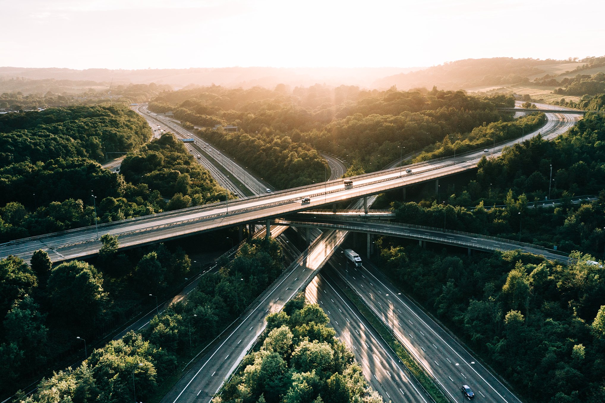 Cars travelling on many different roads that are intertwined.