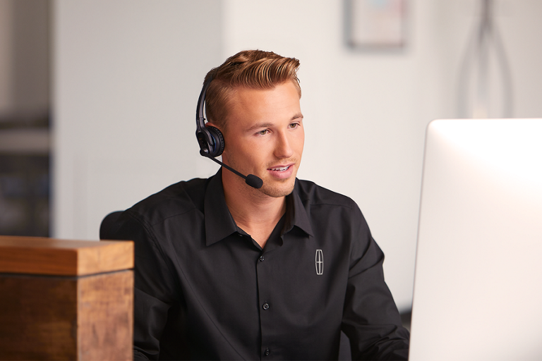 A photo of a Lincoln employee working at the Client Relationship Center