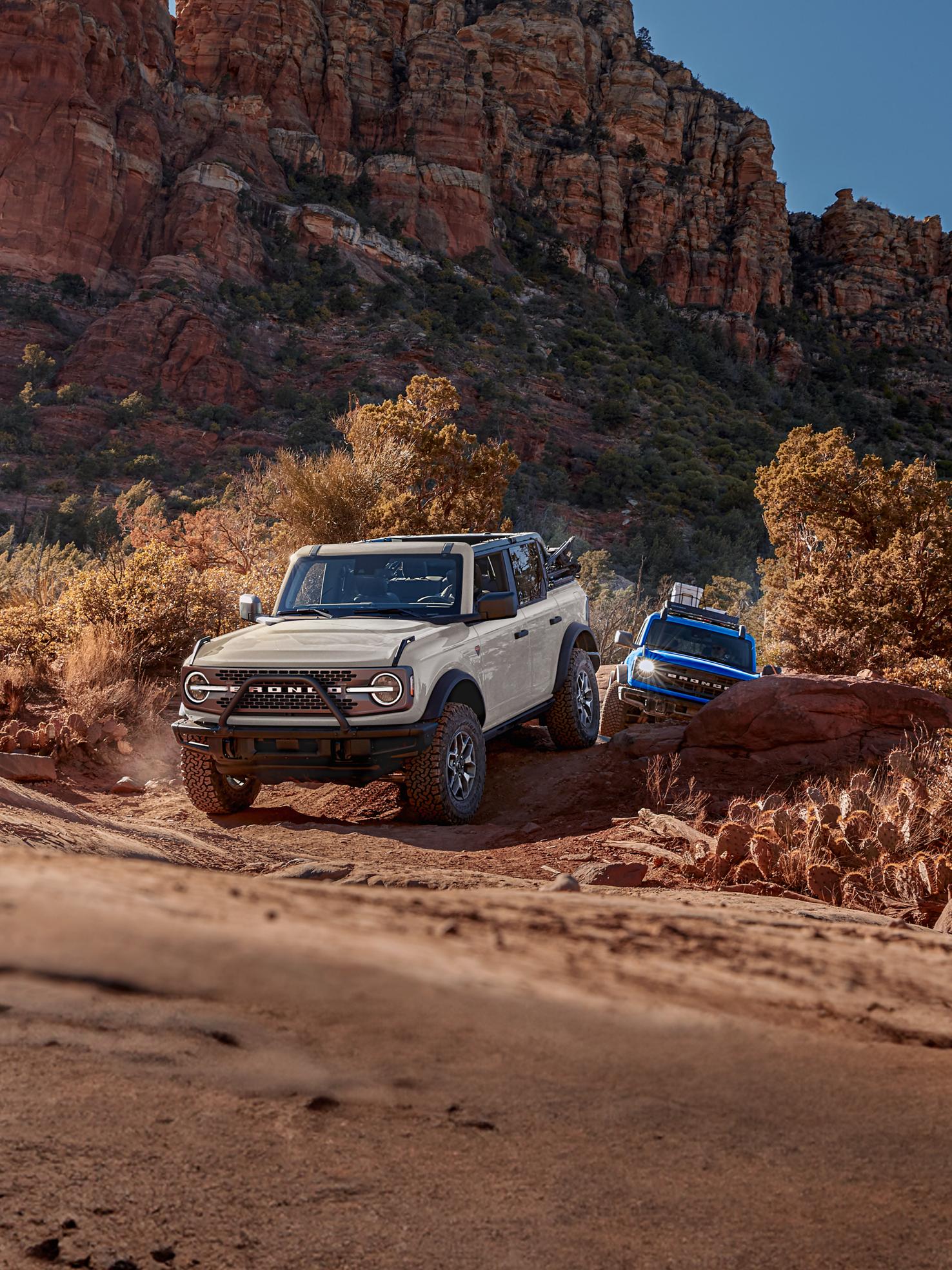Several Ford Bronco® SUVs crawl up boulders