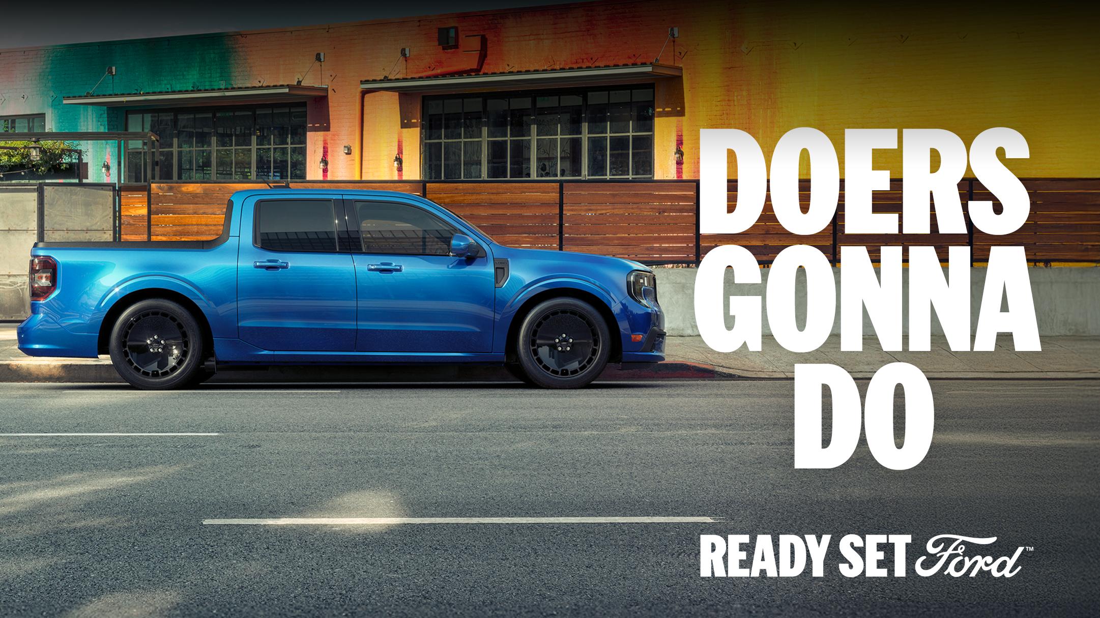 The 2025 Ford Maverick® Lobo™ pickup parked street-side in front of a building with a colorful mural