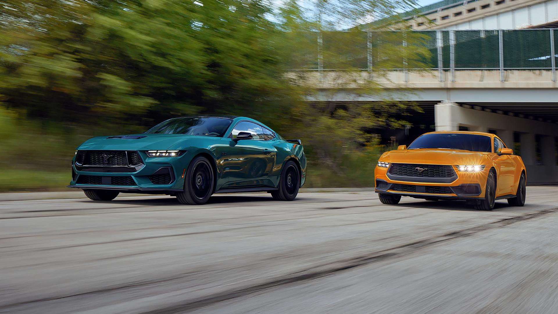 A 2026 Ford Mustang® GT Fastback and a 2026 Ford Mustang® EcoBoost® Fastback being driven on a highway