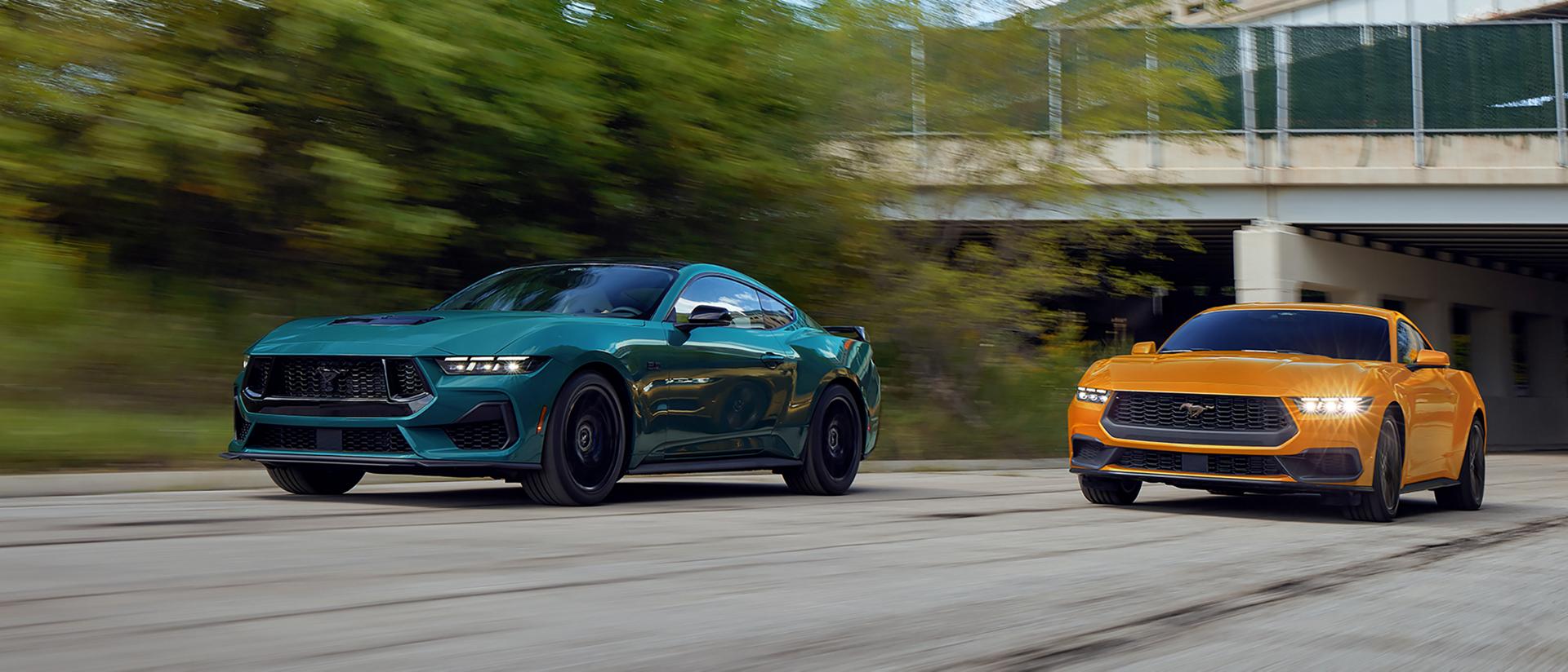 A 2026 Ford Mustang® GT Fastback and a 2026 Ford Mustang® EcoBoost® Fastback being driven on a highway