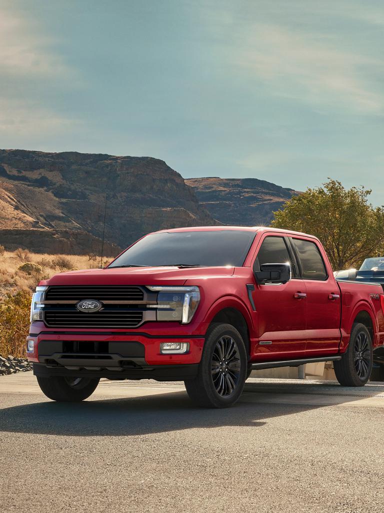 2025 Ford F-150® STX® FX4 pickup in Ruby Red Metallic pulling a boat out of the water